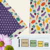 Garden Variety beeswax food wraps in four sizes featuring a vegetable-themed print with carrots, eggplants, squash, and a purple polka dot secondary fabric by Blindhound Farms