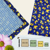 Beeswax food wraps in four sizes with a navy background, yellow floral print, and blue gingham secondary fabric, part of the Midnight Meadow pack by Blindhound Farms