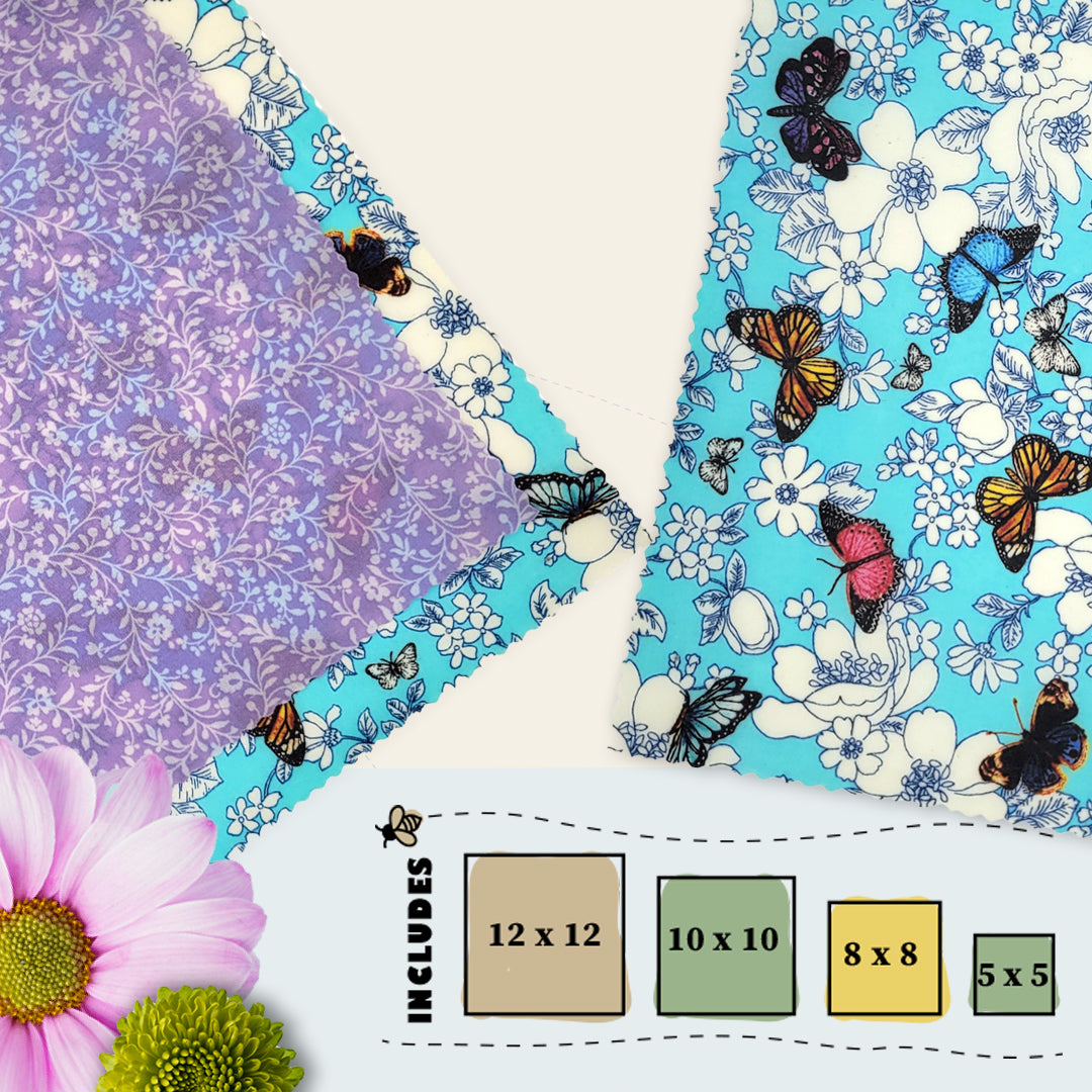 Wildflower Wings beeswax food wraps in four sizes featuring blue floral butterfly print and purple vine secondary fabric by Blindhound Farms